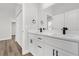 Modern bathroom featuring double sinks, white cabinets, and sleek black hardware at 4761 Sw 142Nd Place Rd, Ocala, FL 34473