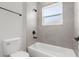 Bathroom with tub and shower combo, updated fixtures, and grey tile at 4761 Sw 142Nd Place Rd, Ocala, FL 34473