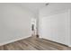 Spacious bedroom with wood-look floors, closet, and a view into the home at 4761 Sw 142Nd Place Rd, Ocala, FL 34473