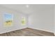 Bright bedroom with hardwood flooring and natural light from two windows at 4761 Sw 142Nd Place Rd, Ocala, FL 34473