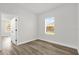 Well-lit bedroom featuring a window with backyard views and an entrance to another room at 4761 Sw 142Nd Place Rd, Ocala, FL 34473