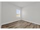 Bright bedroom featuring wood-look flooring, a window, and neutral paint at 4761 Sw 142Nd Place Rd, Ocala, FL 34473