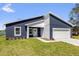 Contemporary blue and white home featuring a two-car garage, crisp white trim, and well-maintained lawn at 4761 Sw 142Nd Place Rd, Ocala, FL 34473