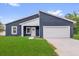 Modern home featuring a blue exterior, white trim, and a well-manicured lawn at 4761 Sw 142Nd Place Rd, Ocala, FL 34473