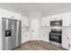 Bright kitchen featuring stainless steel appliances, wooden floors, and ample cabinet space at 4761 Sw 142Nd Place Rd, Ocala, FL 34473