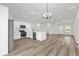 Modern kitchen with stainless steel appliances, white cabinetry, and hard wood floors at 4761 Sw 142Nd Place Rd, Ocala, FL 34473