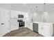 Well-lit kitchen with modern appliances, sleek countertops and stylish pendant lighting at 4761 Sw 142Nd Place Rd, Ocala, FL 34473