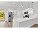 Modern kitchen featuring white quartz countertops, stainless steel appliances, and hardwood floors at 4761 Sw 142Nd Place Rd, Ocala, FL 34473
