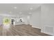 Open-concept living space featuring hard wood floors and a modern kitchen with stainless steel appliances at 4761 Sw 142Nd Place Rd, Ocala, FL 34473