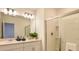 Bathroom featuring double sinks, white cabinets, and a glass-enclosed shower at 4839 Sunflower St, Lake Hamilton, FL 33851