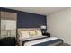 Cozy bedroom showcasing a bed with plush pillows, a stylish headboard, and complementing nightstands with lamps at 4839 Sunflower St, Lake Hamilton, FL 33851