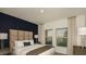 Bright main bedroom showcasing a plush bed, large windows, and elegant decor at 4839 Sunflower St, Lake Hamilton, FL 33851