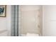 Clean and bright bathroom with a shower-tub combo and neutral-colored shower curtain at 4940 Bluebell Ct, Lake Hamilton, FL 33851