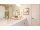 Bright bathroom with double sinks, quartz counters, and a beautifully tiled shower, offering a spa-like experience at 4940 Bluebell Ct, Lake Hamilton, FL 33851