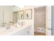 Bright bathroom featuring double sinks, white cabinetry, and a shower-tub combo in an adjacent room at 4940 Bluebell Ct, Lake Hamilton, FL 33851