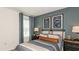 Comfortable bedroom with blue accents, stylish decor, and ample natural light creating a relaxing atmosphere at 4940 Bluebell Ct, Lake Hamilton, FL 33851