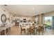 Open-concept dining area next to a bright kitchen and overlooking a backyard at 4940 Bluebell Ct, Lake Hamilton, FL 33851