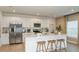 Modern kitchen with stainless steel appliances, white cabinets, a large island, and pendant lighting at 4940 Bluebell Ct, Lake Hamilton, FL 33851