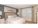 Calming main bedroom with neutral tones, complemented by large windows with decorative drapes at 4940 Bluebell Ct, Lake Hamilton, FL 33851
