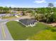 Rear aerial view of single-story home with a dark roof, sliding glass doors to the backyard and ample green space at 531 Marion Oaks Blvd, Ocala, FL 34473
