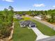 Beautiful single-story home with a dark roof and attached two-car garage surrounded by green lawns and trees in a quiet neighborhood at 531 Marion Oaks Blvd, Ocala, FL 34473