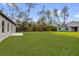 Expansive backyard featuring a lush lawn and a wooded area, perfect for outdoor activities and privacy at 531 Marion Oaks Blvd, Ocala, FL 34473