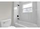 Bright bathroom with a white tile shower and black fixtures at 531 Marion Oaks Blvd, Ocala, FL 34473