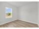 A clean, vacant bedroom featuring a window and wood-look floors at 531 Marion Oaks Blvd, Ocala, FL 34473