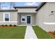 Close-up of home's front door and well-manicured lawn at 531 Marion Oaks Blvd, Ocala, FL 34473