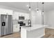 Bright, open kitchen features stainless steel appliances, pendant lighting, and a spacious island at 531 Marion Oaks Blvd, Ocala, FL 34473