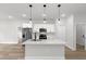 Bright, open kitchen features stainless steel appliances, pendant lighting, and a spacious island at 531 Marion Oaks Blvd, Ocala, FL 34473