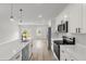 Bright kitchen with stainless steel appliances, white cabinets, and a large island with a sink at 531 Marion Oaks Blvd, Ocala, FL 34473