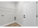 Well-lit laundry room with a white wire shelf, flooring, and a white door at 531 Marion Oaks Blvd, Ocala, FL 34473