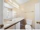 Well-lit bathroom features a spacious countertop, white fixtures, and a large mirror at 605 Swallow Ct, Apopka, FL 32712
