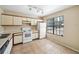 Functional kitchen with ample cabinet space, tile flooring, and natural light from the window at 605 Swallow Ct, Apopka, FL 32712