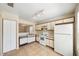 Well-lit kitchen with tile flooring, white appliances and cabinets, and a sink with a view at 605 Swallow Ct, Apopka, FL 32712
