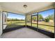 View from the screened porch offering an expansive view of the backyard and pond at 605 Swallow Ct, Apopka, FL 32712