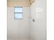 Bright shower with white subway tile, shower head, window, and neutral flooring at 605 Swallow Ct, Apopka, FL 32712