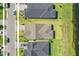 Aerial view highlighting a residential area with neatly arranged homes and a pond nearby at 6239 Woodhaven Village Dr, Port Orange, FL 32128