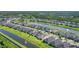 Expansive aerial view of a Primary-planned community featuring water features and lush landscaping at 6239 Woodhaven Village Dr, Port Orange, FL 32128