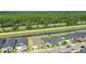 Community aerial view showcasing homes situated alongside a serene water feature and green spaces at 6239 Woodhaven Village Dr, Port Orange, FL 32128