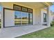 Covered back patio with concrete floor and view of large windows and grassy backyard at 6239 Woodhaven Village Dr, Port Orange, FL 32128