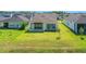 A spacious backyard provides ample room for outdoor activities and gardening with a covered patio at 6239 Woodhaven Village Dr, Port Orange, FL 32128