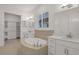 Luxurious bathroom featuring dual vanities, a soaking tub, and a walk-in closet at 6239 Woodhaven Village Dr, Port Orange, FL 32128