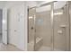 Bright bathroom features glass shower with tile surround and a built-in seat at 6239 Woodhaven Village Dr, Port Orange, FL 32128