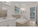 Well-lit bathroom with a soaking tub, dual sinks, and a separate shower area at 6239 Woodhaven Village Dr, Port Orange, FL 32128