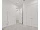A bright bedroom with neutral carpet, a ceiling light, closet, and a hallway view at 6239 Woodhaven Village Dr, Port Orange, FL 32128