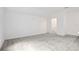 Bright bedroom boasts neutral walls, carpeted floors and an en-suite bathroom at 6239 Woodhaven Village Dr, Port Orange, FL 32128