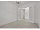 Bright bedroom with white walls, light wood flooring and French doors to another room at 6239 Woodhaven Village Dr, Port Orange, FL 32128