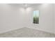 Bright bedroom with neutral carpet and a large window bringing in natural light at 6239 Woodhaven Village Dr, Port Orange, FL 32128